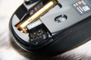 Récepteur USB et compartiment de rangement d’une souris sans fil.